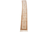 The full length of a narrow vintage Tabriz runner, showing its continuous floral pattern on a cream field.