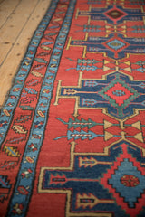 Angled view of a Northwest Persian runner's geometric medallions and colorful meandering leaf border.