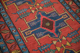 Serrated leaf and arrowed finials on a geometric medallion of a collector's Persian rug.
