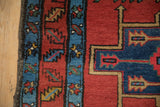 Detail of the meandering leaf border and secured charcoal selvage on an antique Persian runner.