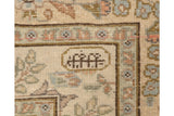 The weaver's insignia woven within a cartouche on the vintage Tabriz carpet's minor border.