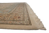 Side view of a vintage Tabriz rug's floral border, plush pile, and clean, intact cream fringe.