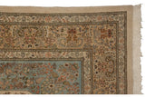 A weaver's insignia visible in the corner of a vintage Tabriz carpet's intricate floral border.