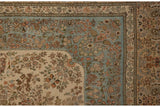 Weaver's insignia woven into the floral minor border of a vintage Tabriz carpet corner.