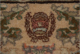 Detail of the woven Cyrus Crown trademark in the border of a vintage Tabriz carpet.