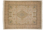 Vintage Persian Tabriz carpet with a scalloped medallion and forest scene of animals and birds on a cream field.