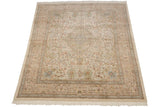 Angled view of a vintage Tabriz carpet showing its intricate pictorial design and neutral palette.
