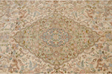 Close-up of the vintage Tabriz carpet's scalloped roundel center medallion in sea foam green.