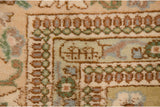 Close-up of the hand-knotted weaver insignia within the minor border of a vintage Persian Tabriz carpet.