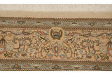The Cyrus Crown trademark woven into the main floral border of a vintage Persian Tabriz carpet.