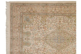 Corner view of a vintage Tabriz carpet showing the floral border, dense pile, and clean ivory fringe.