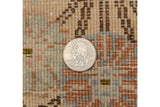 Full, even pile and dense weave of the hand-knotted vintage Tabriz carpet, with a coin for scale.