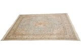 Angled view of the vintage Tabriz square carpet showcasing its full design and ivory fringe.