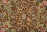 Close-up of a floral blossom showing the full, dense pile of the hand-knotted Tabriz carpet.