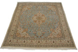 High-angle view of a vintage Tabriz square carpet with a powder blue field and intricate floral medallion.