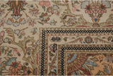 Close-up of the weaver's insignia woven into the ivory minor border of the vintage Tabriz carpet.
