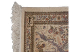 Vintage Tabriz rug corner with cream fringe, weaver signature, and dusty mauve bird.