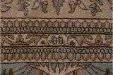 Tabriz carpet border detail: weaver insignia, Cyrus Crown, blossomed motifs in dusty rose, powder blue.