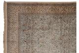 Tabriz rug upper corner, fringe, beige border with deer and cypress trees.