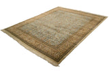 Vintage Tabriz carpet from a corner angle, showing the light blue pictorial field and beige borders.