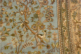 Stylized deer and blossoming trees in a pictorial forest scene on a vintage Tabriz rug.