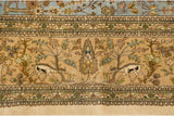 Leaping deer and cypress trees detailed within the pictorial main border of a vintage Tabriz.