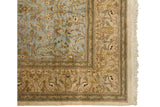Deer and peacocks in the beige pictorial border of a vintage hand-knotted Tabriz carpet.