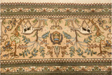 Weaver insignia detail with flanking bird motifs on a vintage Persian Tabriz carpet border.