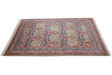Angled view of a vintage Indian carpet, highlighting the carved texture within its trellis pattern.