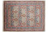 Corner detail of a vintage Indian carpet highlighting the carved pile texture and floral border.