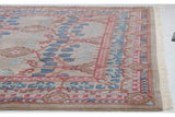 Corner detail of a vintage Indian carpet highlighting the carved pile, floral border, and clean white fringe.