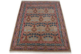 Corner view of a vintage rug showing the carved texture, floral border, and neat white fringe.