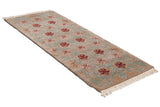 Indian Arts and Crafts runner with carved vines, blush, red palmettes on a beige field.