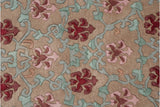 Hand knotted vintage Indian rug detail: carved beige, sea foam, and dusty rose palmettes.
