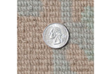 Hand-knotted pile with shallow carved contour, beige and sea foam green, quarter for scale.
