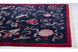 Detail of the vintage rug's carved pile, with an endless knot motif against the navy field.