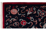 Carved ribbon motifs, red border, and white fringe detail of a vintage Peking carpet.
