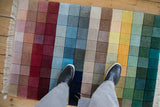Modern Indian rug with textured rainbow color blocks and carved contours.