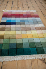 Shallow carved contour, rainbow color blocks, and white fringe on a vintage Indian Modern rug.