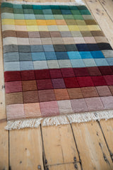 Carved rainbow color blocks with graduating shades on vintage Indian modern rug, with fringe.