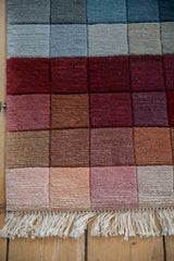Vintage Indian Modern rug showing fringe, shallow carved texture, and rainbow color transition.