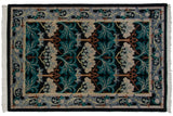 Vintage Indian William Morris carpet with sprawling floral motifs in teal and silver on a charcoal black field.