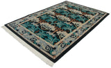 Angled view of a vintage William Morris carpet highlighting its lush pile and floral pattern.