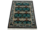 Perspective view of a vintage Indian rug with Arts and Crafts floral motifs in teal and silver.