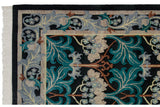 Rug corner with original side cord selvage and a scrolling teal and silver floral border.