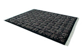 Angled view showing the staggered floral rows of a vintage Indian Damask design carpet.