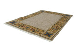 Shallow carved contour and ornate Savonnerie border with floral tendrils in beige and saffron.
