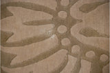 Shallow carved contour detail of the Savonnerie rug's tone-on-tone floral pattern.