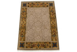 Corner of vintage Indian Savonnerie carpet with ornate floral border and tone-on-tone blossomed field.