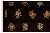 Shallow carved pile outlining floral bouquets against a dark trellis pattern, with ivory fringe.